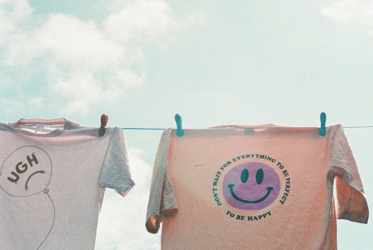 Clothes hanging on a washing line outdoors against a blue sky.