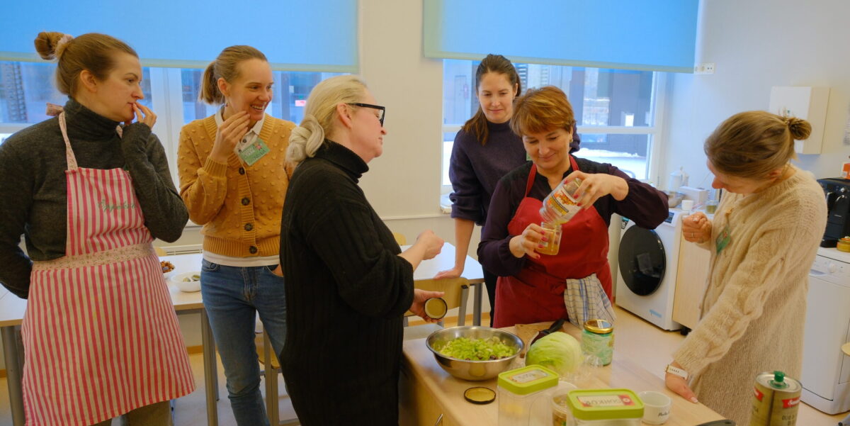 Participants preparing food together during a practical food waste prevention workshop in Estonia